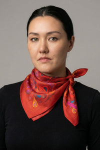 Red satin twill scarf with symmetrical paisley print in purple, yellow and blue accents
